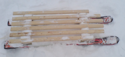 ski wood sledge in snow